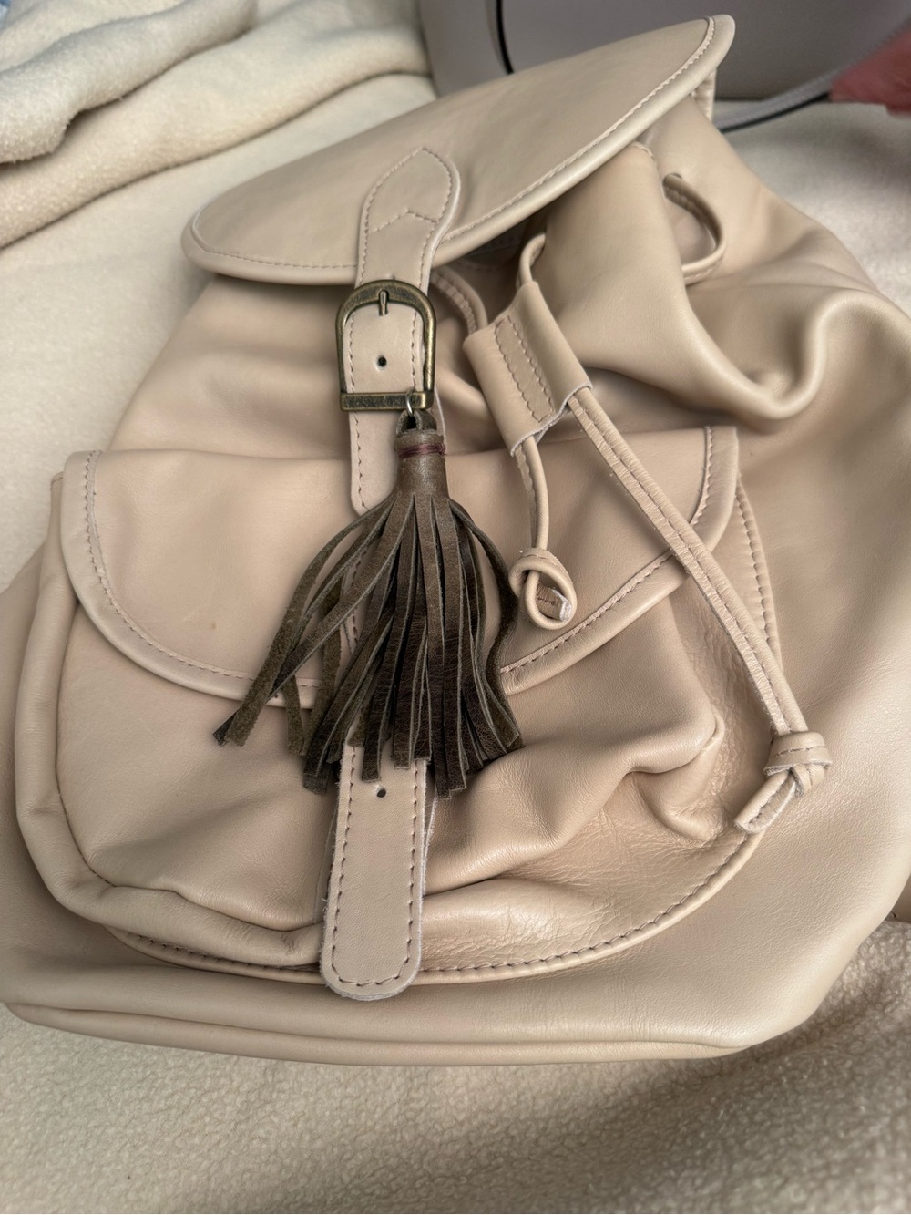 Cream Leather Drawstring Backpack with Tassel Accent